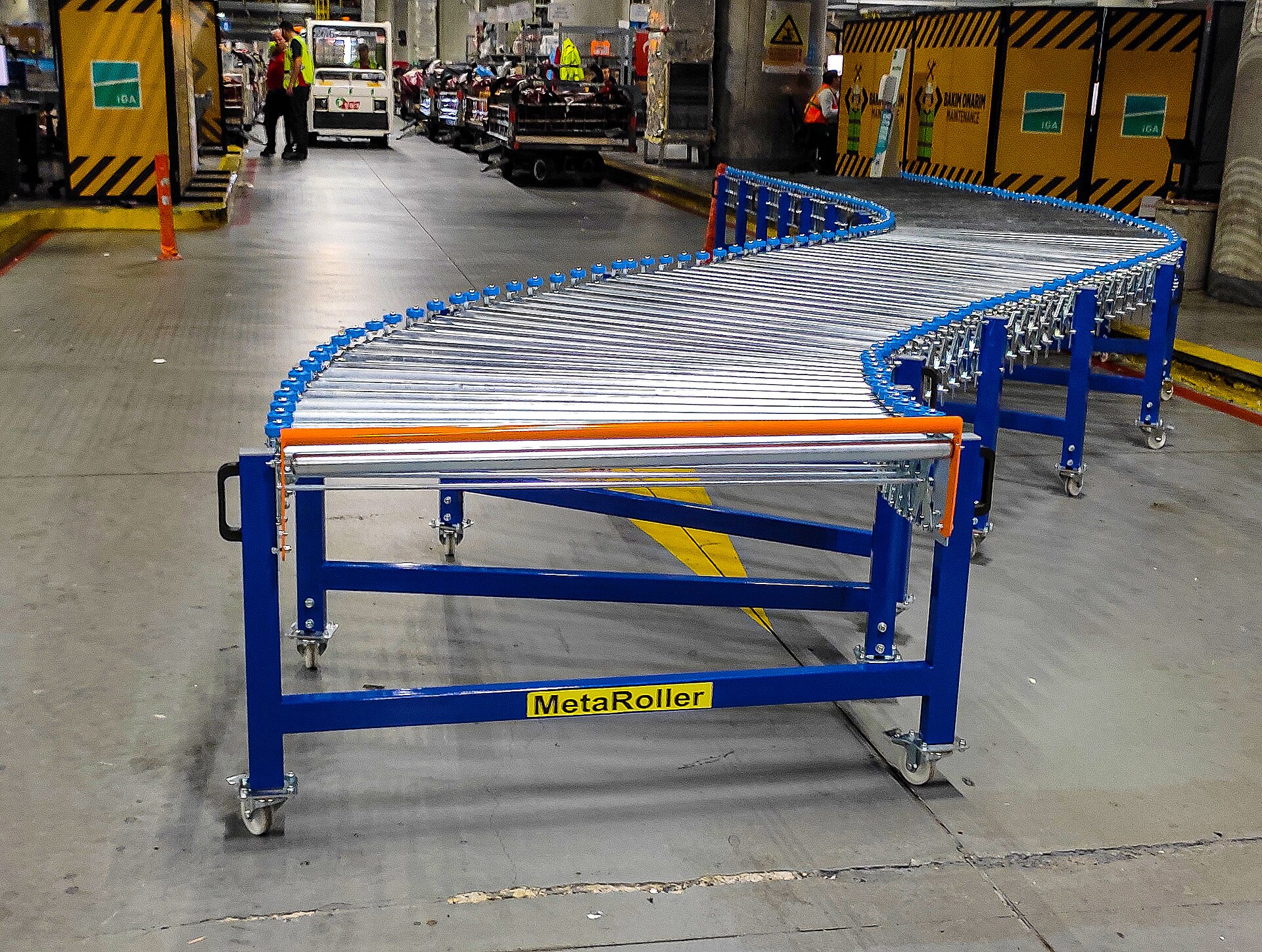 A curved roller conveyor on a warehouse floor